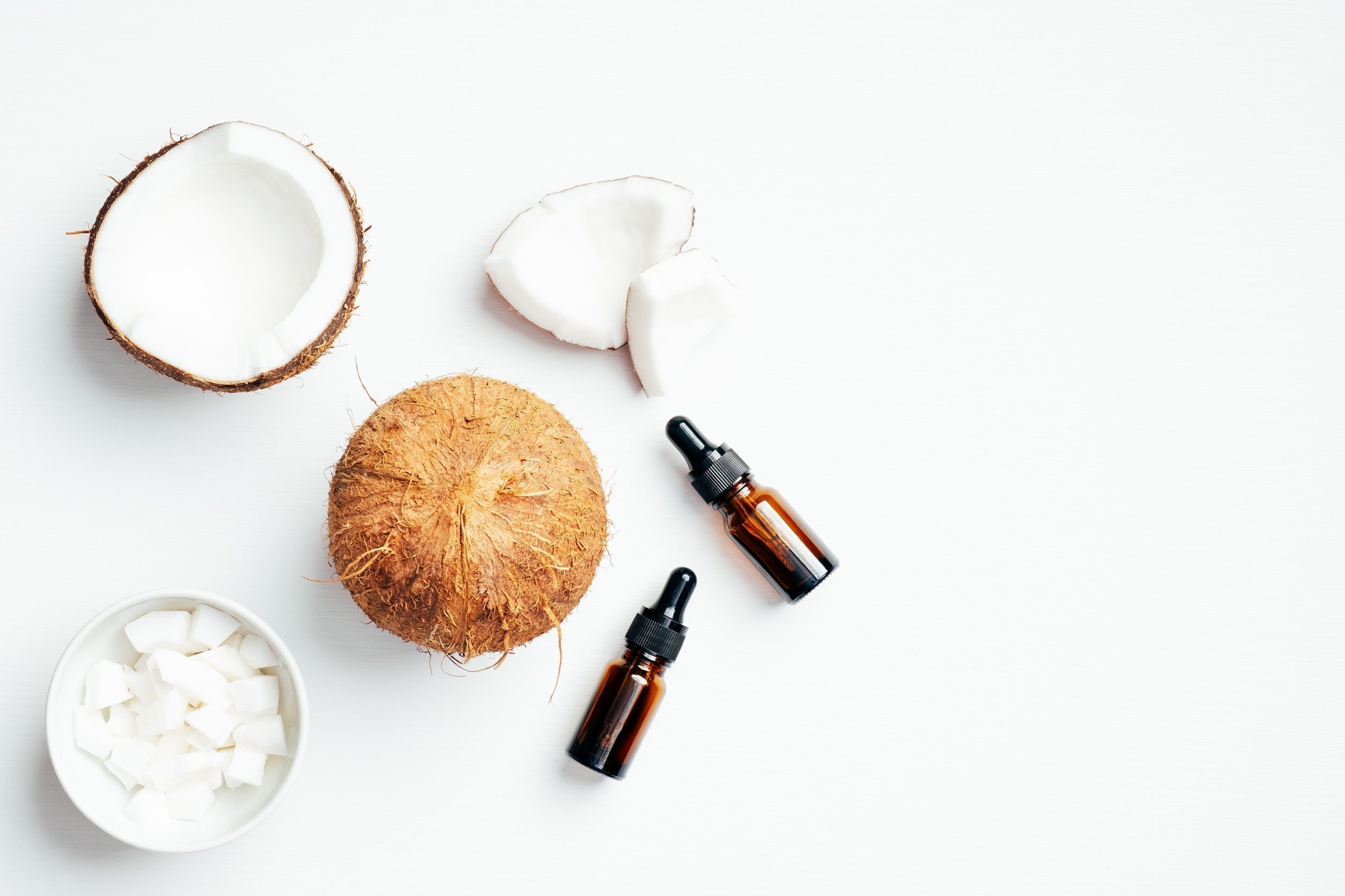 Flat lay composition with coconut oil on white background.
