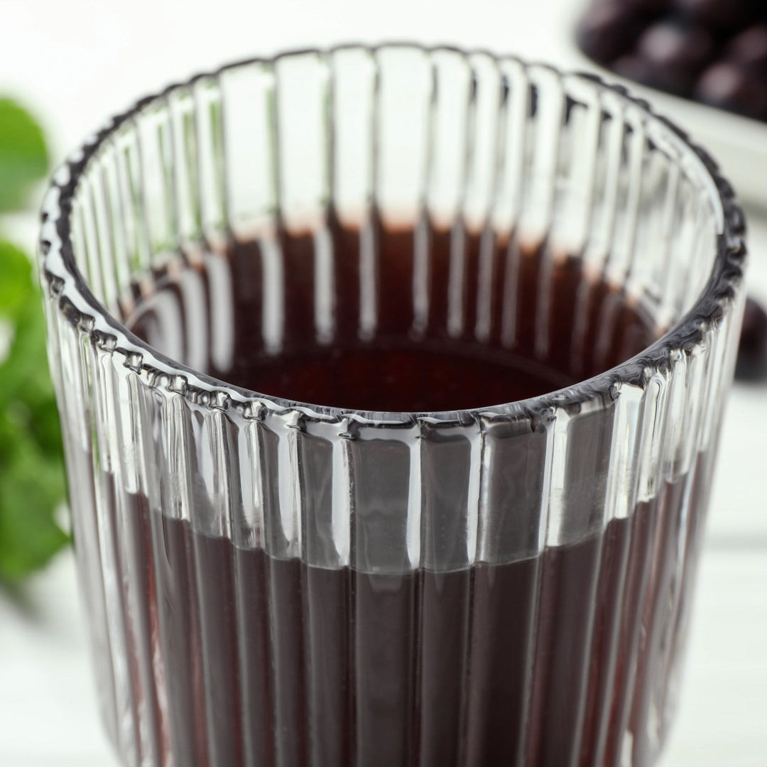 Dark purple acai glycerin extract in a glass container.