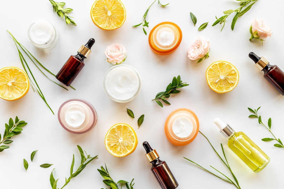 Herbal and flowers cosmetic flat lay with citrus oil and skin cream