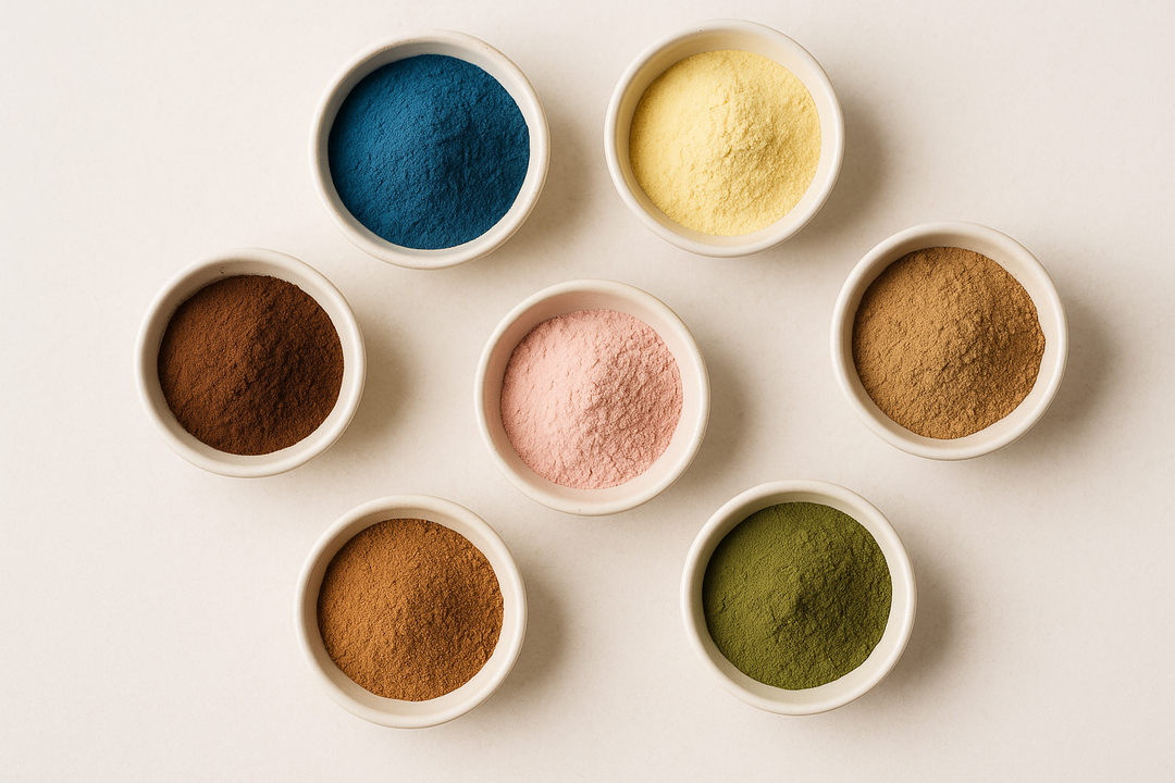 Powdered botanical extracts including blue spirulina, chlorella, tart cherry, and tepezcohuite displayed in bowls on a neutral background.