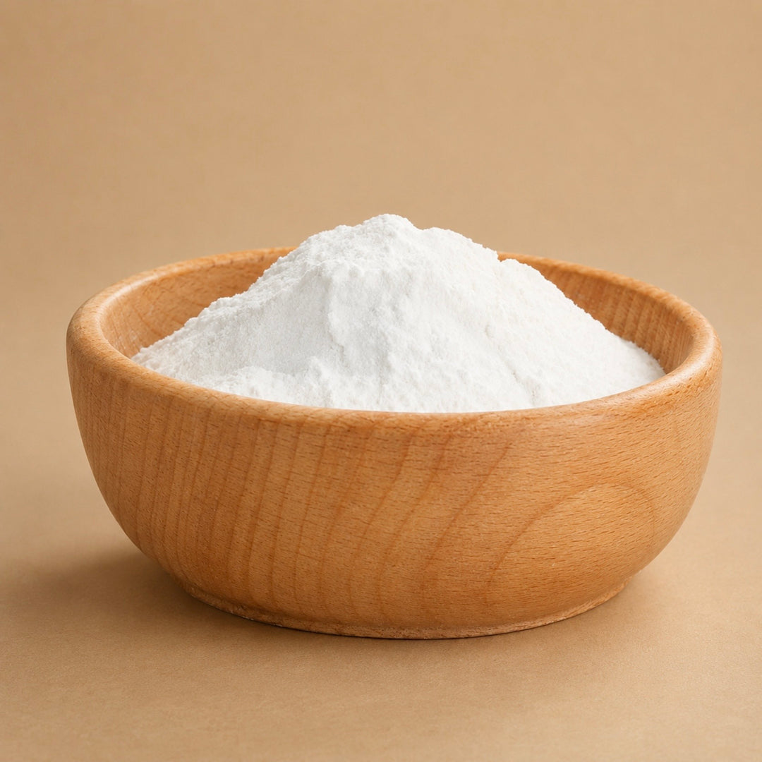 Wooden bowl filled with white powder on a beige background
