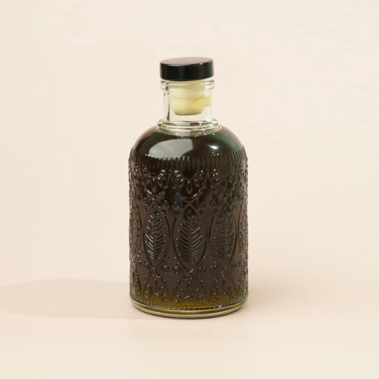 Decorative bottle with intricate patterns on a beige background