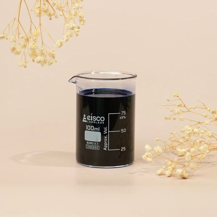 Beaker with dark liquid labeled 'Leisco Laboratories' on a beige background with decorative elements.