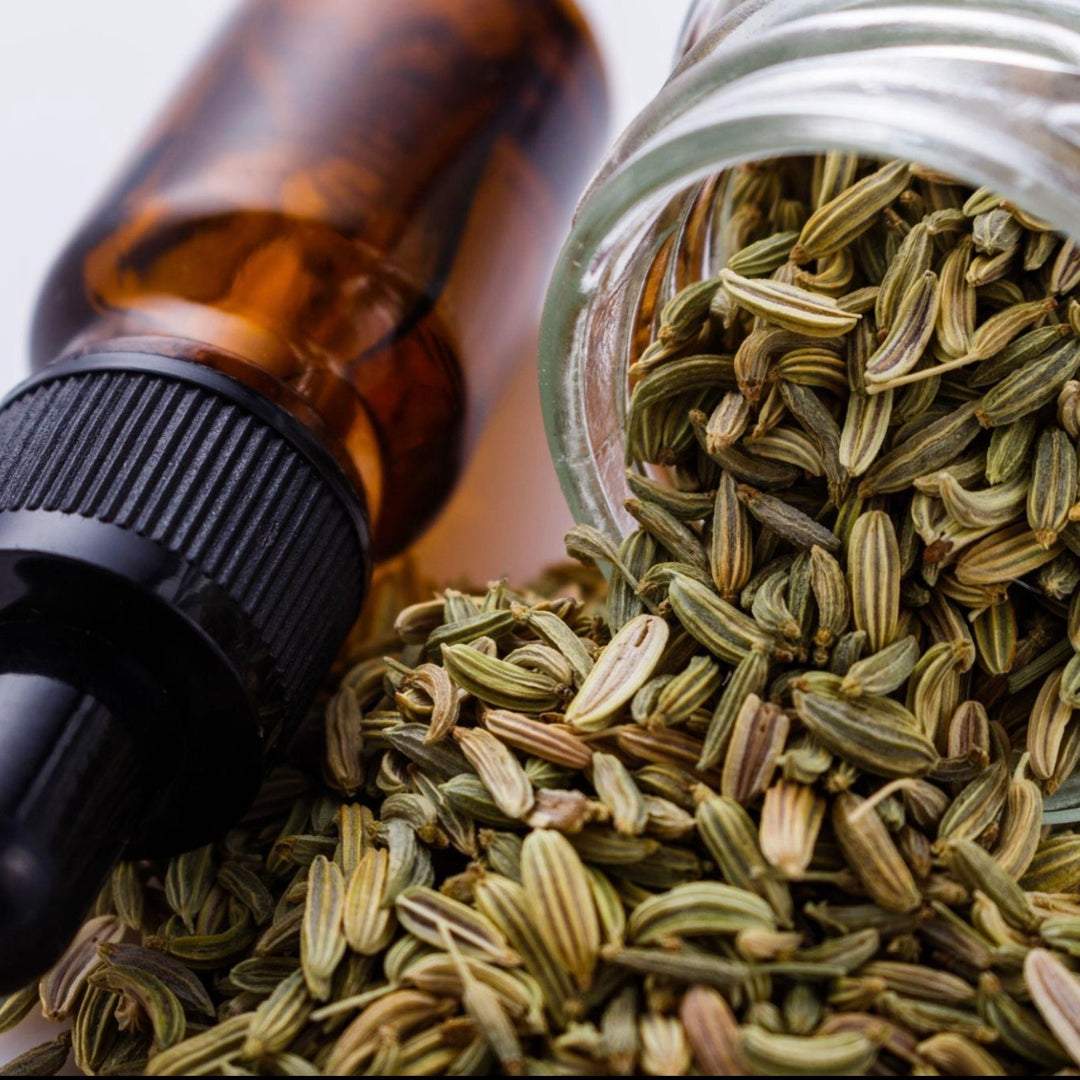 Fennel seeds with a dropper bottle on a light background