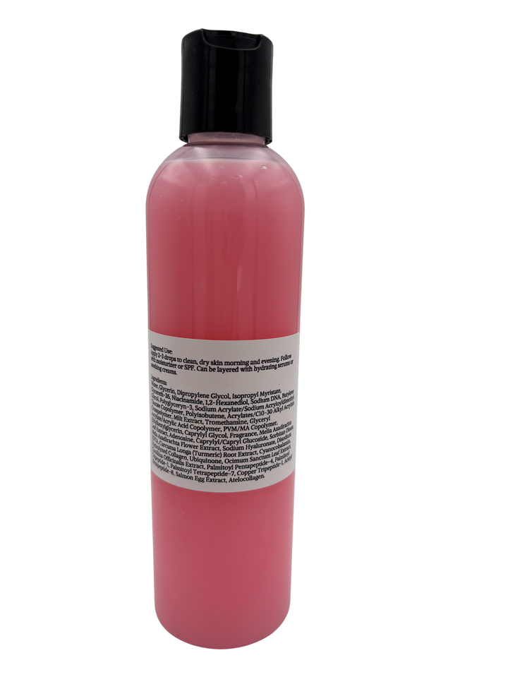 A clear bottle of pink face serum.